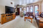 Family room with wood fireplace, sofa and TV, games, puzzles